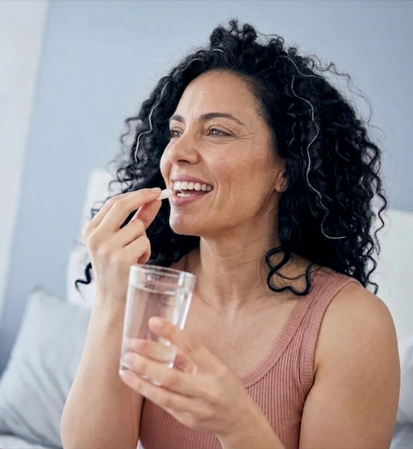 Woman enjoying Restore probiotic with water